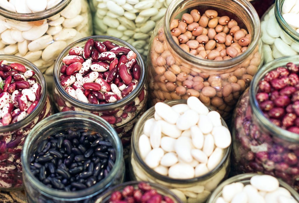 Different beans in glass jars